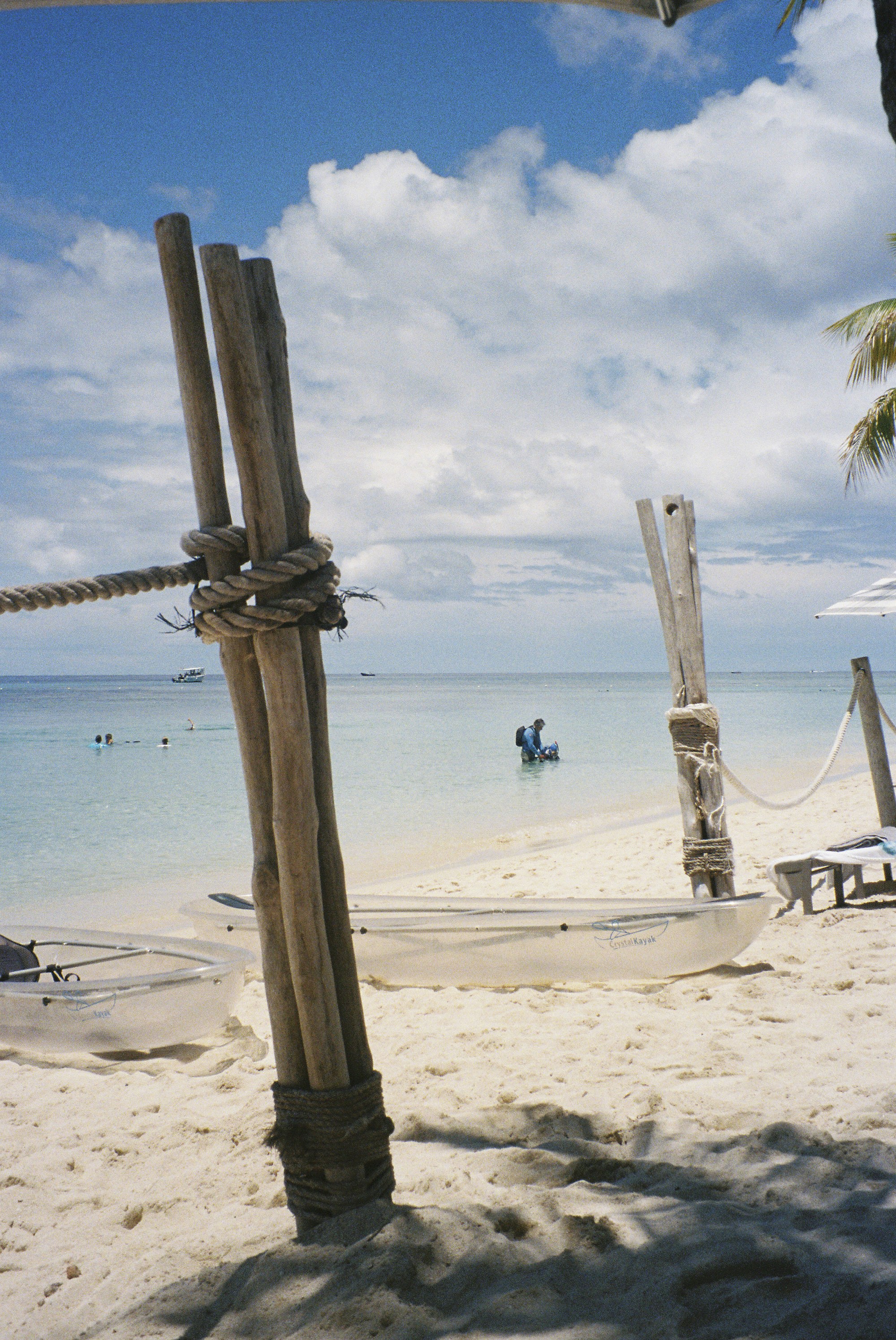 Tropical beach with wooden posts and calm ocean
