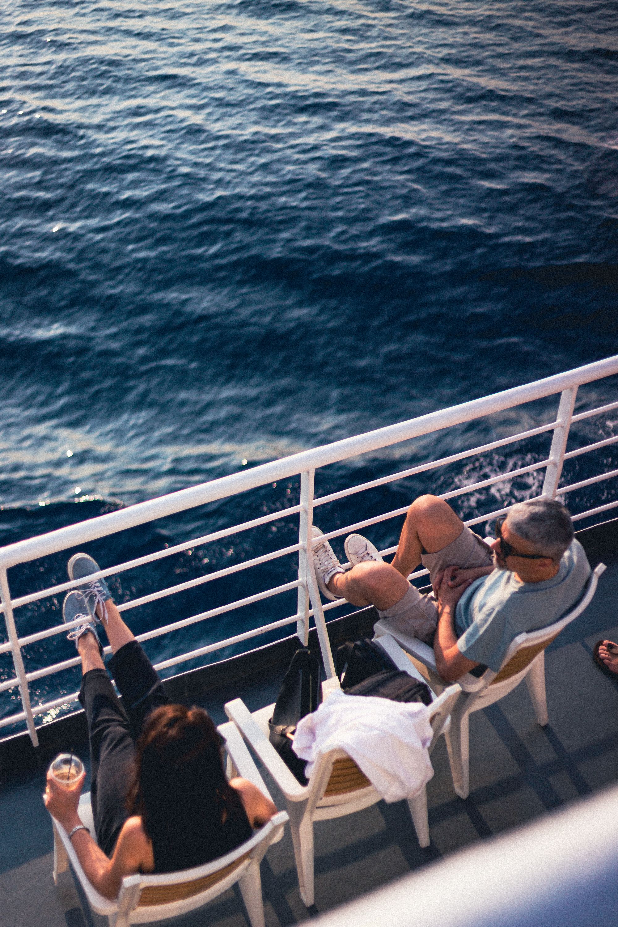 Couple relaxing on cruise ship deck overlooking ocean