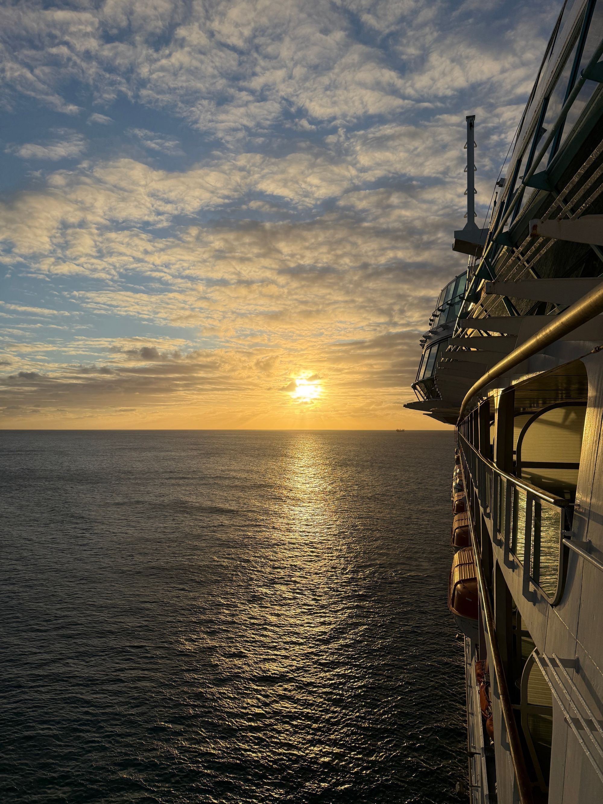 Sunset view from cruise ship balcony overlooking calm Caribbean waters