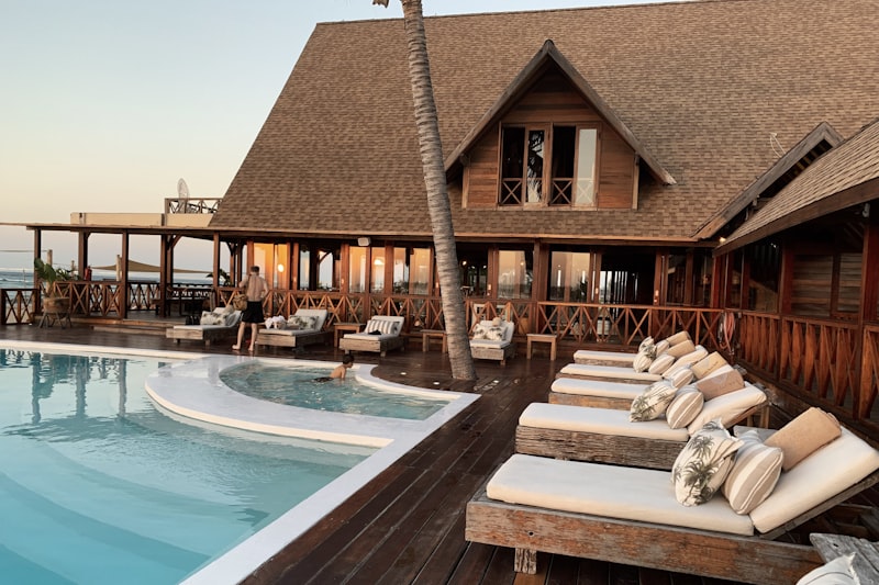 Aerial view of a luxury Caribbean resort with infinity pool and turquoise water — the kind of escapes we cover