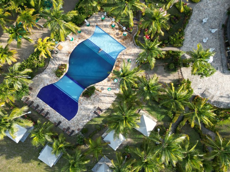 Aerial view of a turquoise Caribbean beach and resort shoreline.