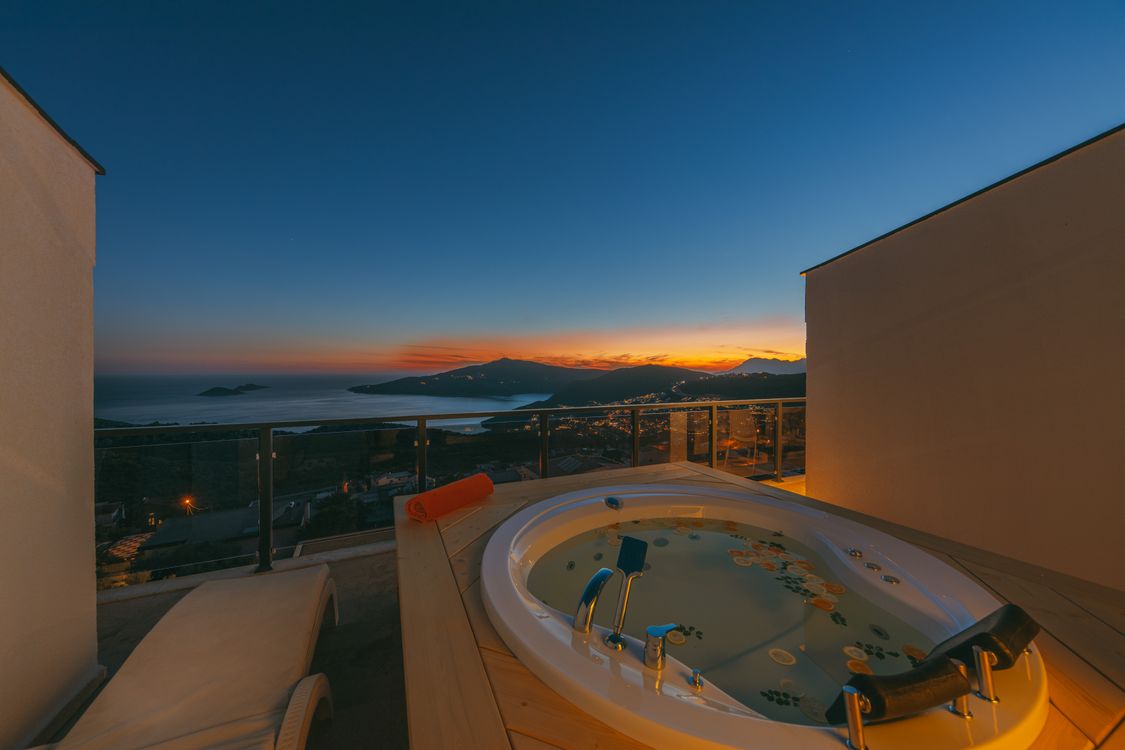 Luxury terrace jacuzzi with scenic coastal sunset view