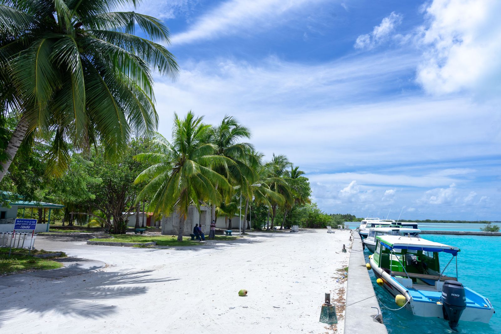 Colorful boats along a Belize beach — the local maritime culture surrounding resort properties.