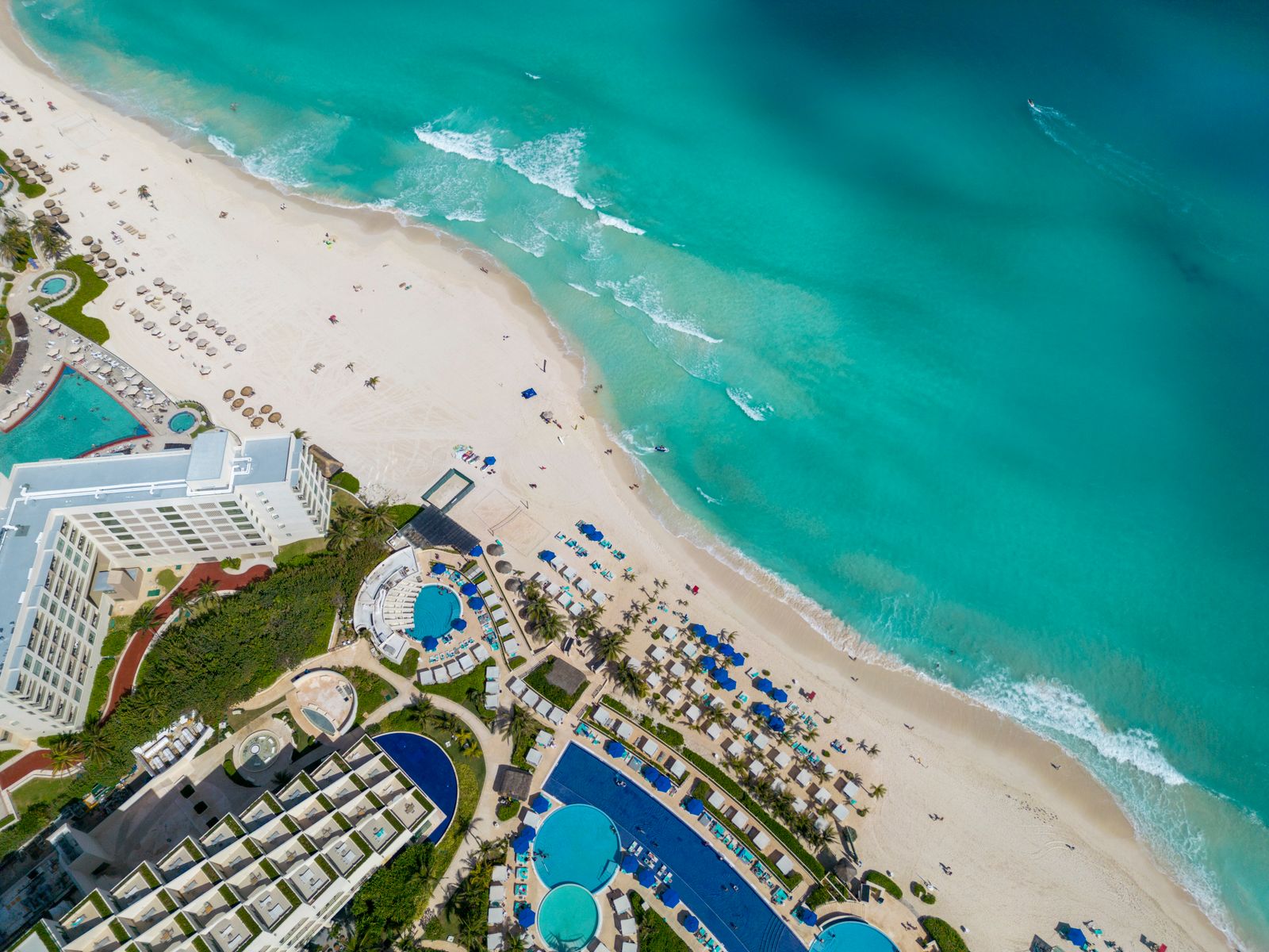 Calm turquoise shoreline with gentle waves and clear tropical water.