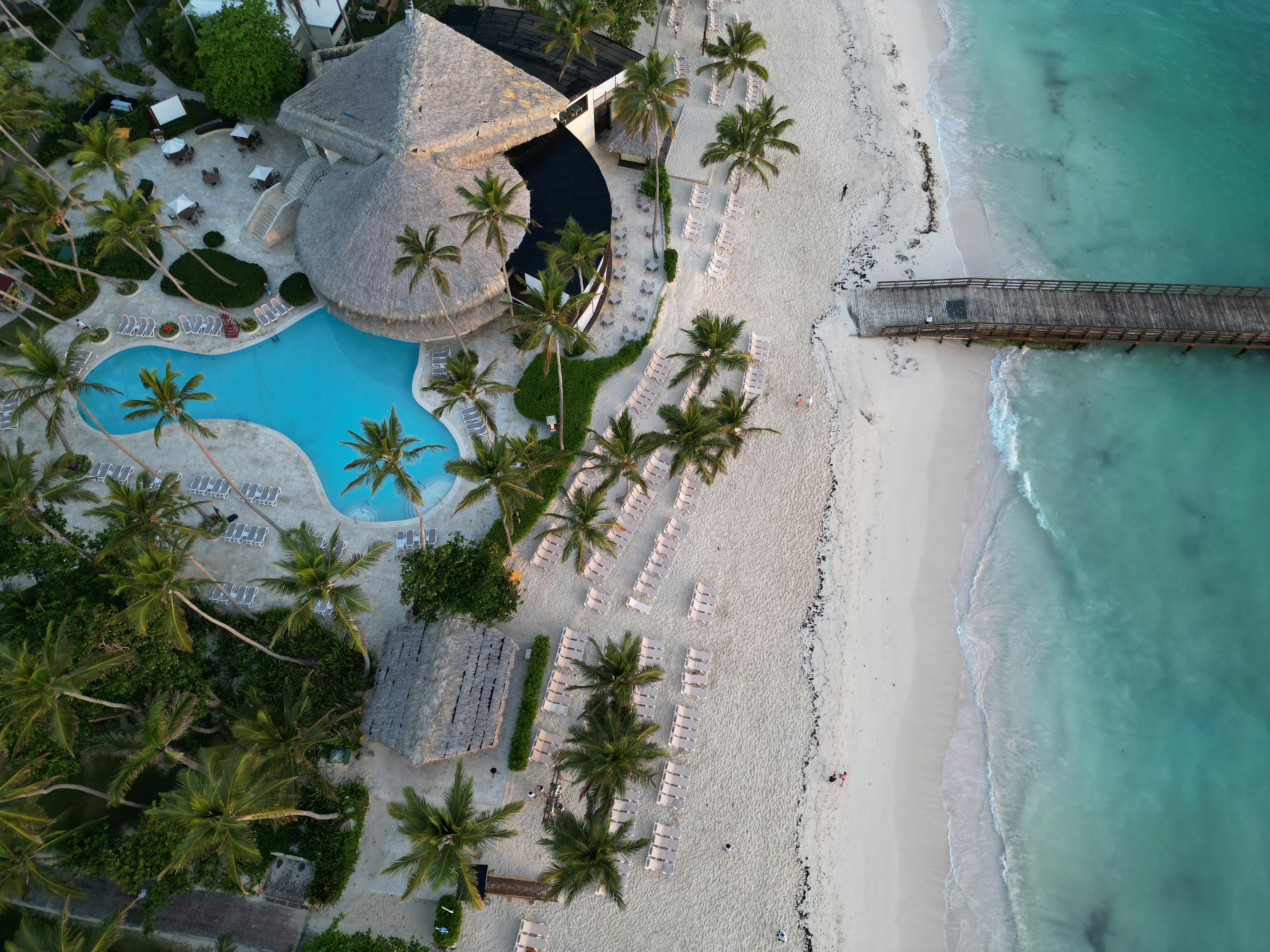 A tropical Caribbean resort pool overlooking turquoise water