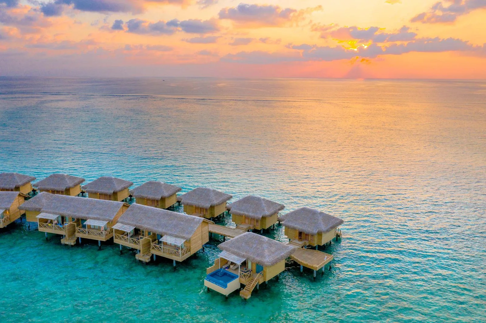 Saint Vincent overwater bungalows with volcanic rock backdrop