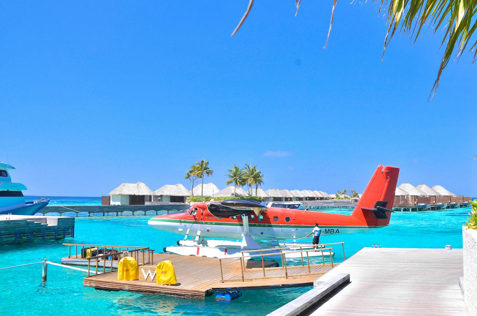 Romantic honeymoon resort pool with infinity edge overlooking turquoise Caribbean waters.