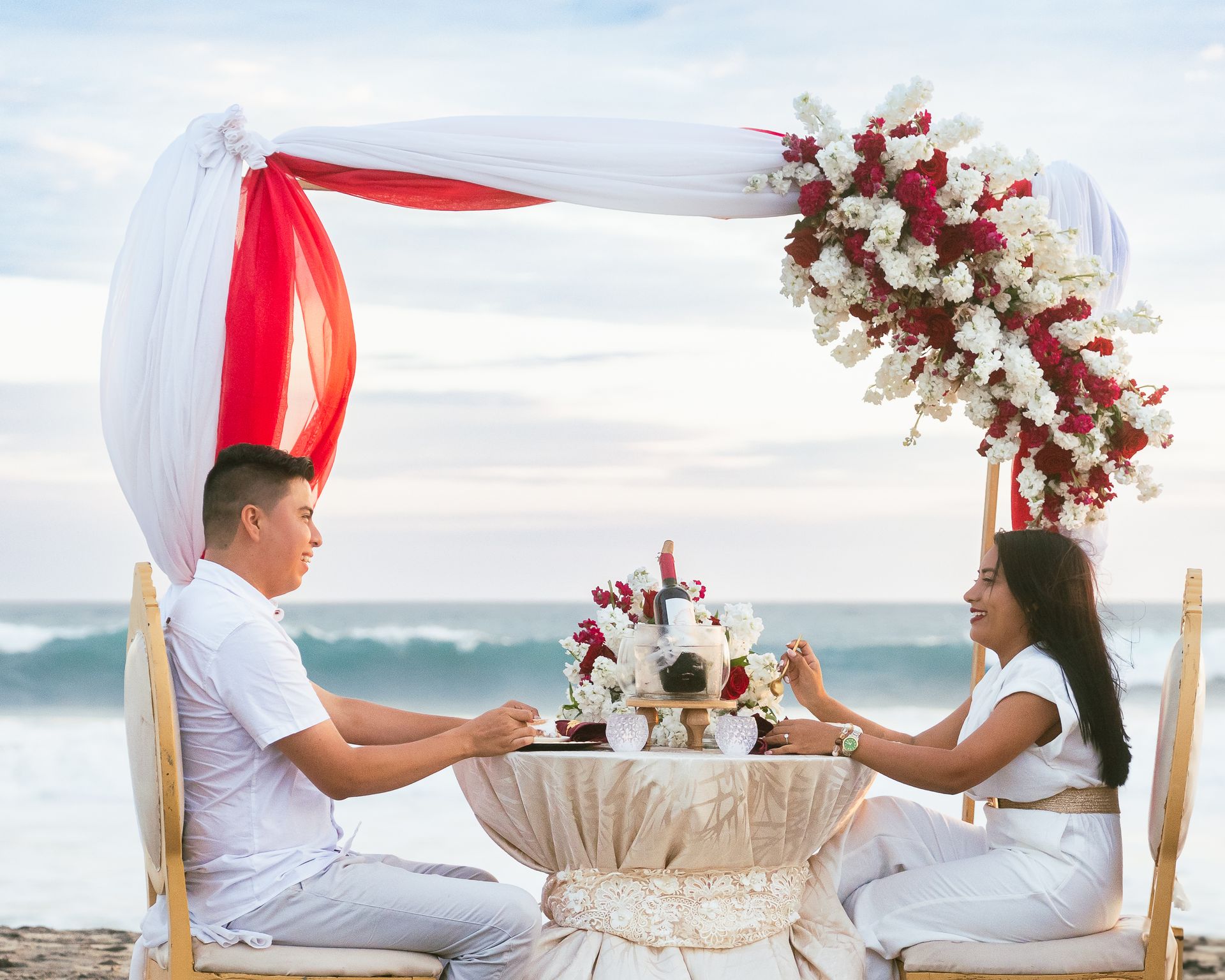 Romantic beachside dinner with ocean backdrop